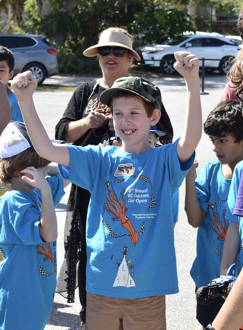 10-year-old Ezra Helton of Team Helton cheers following a victory.