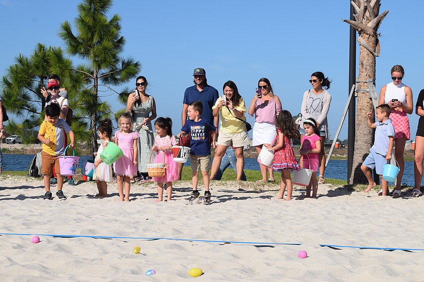 Families line the sand volleyball courts as the countdown to the start of the egg hunt begins.