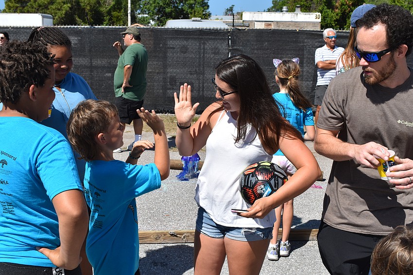 9-year-old Anderson Perkins of All-Terrain Pain is congratulated by his mother Savannah Perkins after a competition.