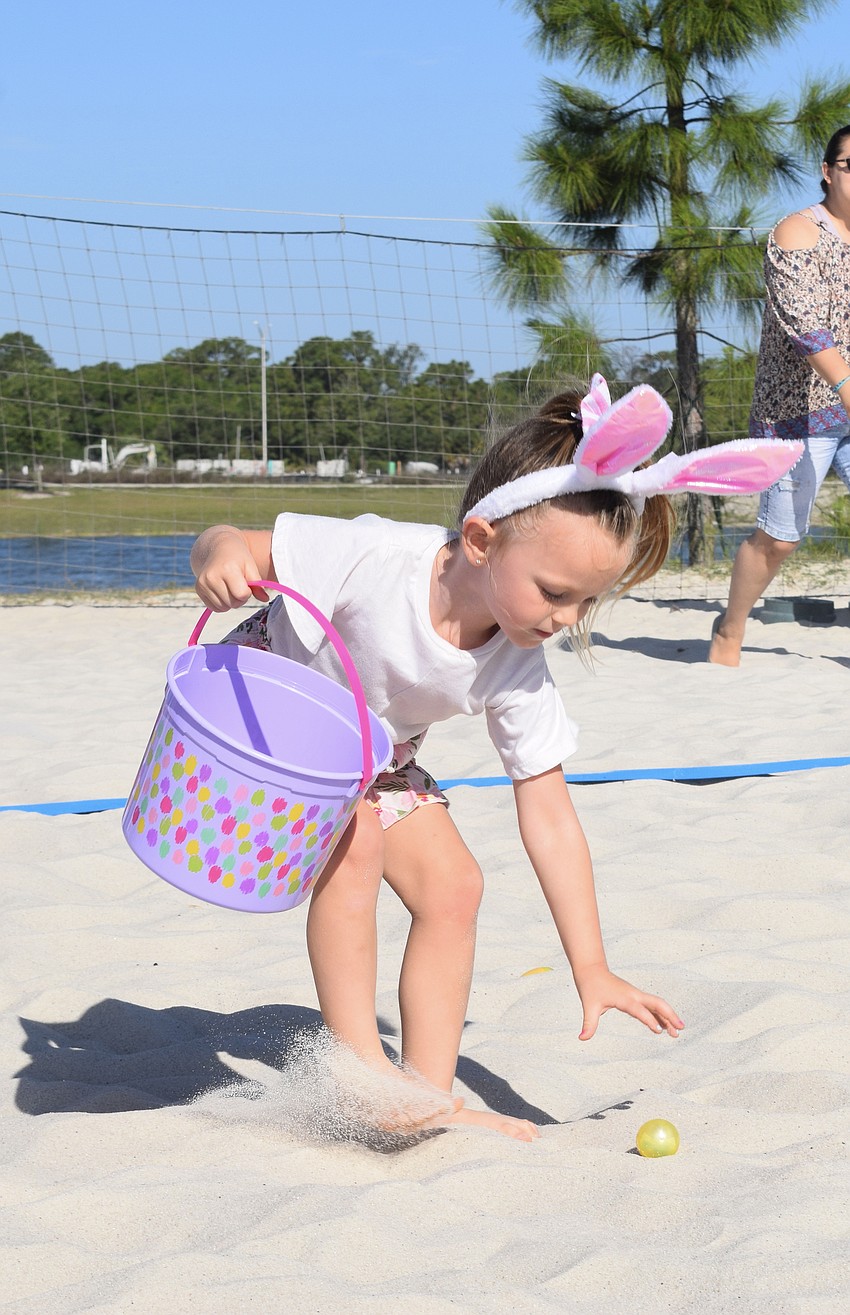 Myakka City's Harper Davis, who is 4, collects as many eggs as she can during the hunt.