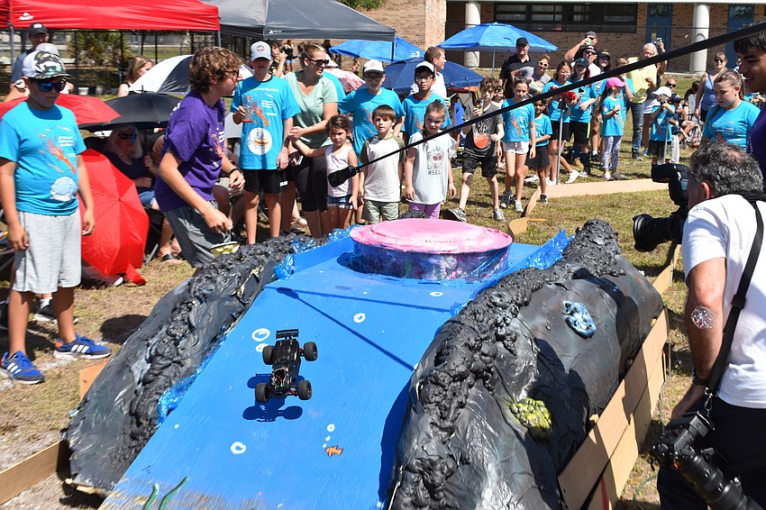 A car makes the journey over a pink jellyfish.