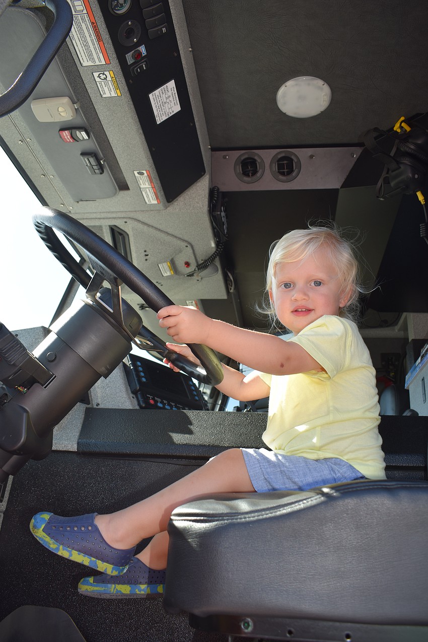 Lakewood Ranch's Meyer Garfield, who is 2, has his chance to drive a Sarasota County Fire Department firetruck.