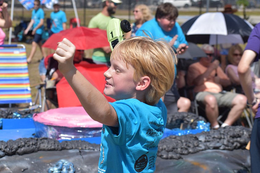 9-year-old Patrick English of the Megalodons celebrates a victory.