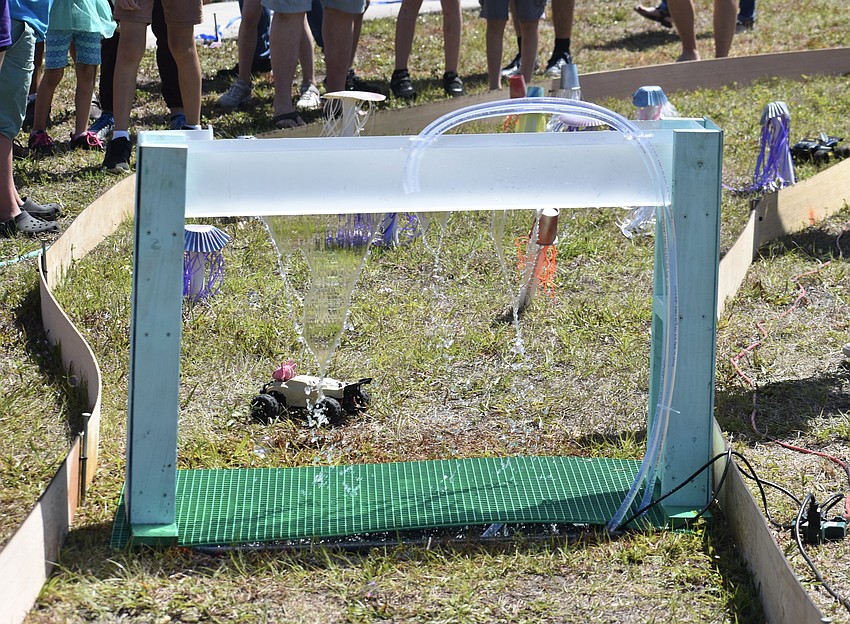 A car approaches the waterfall in the obstacle course.