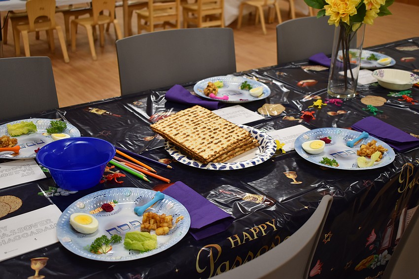 Plates included the traditional items of the Seder meal: zeroa, a shankbone (substituted here with a pencil eraser) representing the sacrificial lamb in the Passover story; beitzah, an egg representing a holiday sacrifice traditionally offered at the Temple in Jerusalem; charoset, a sweet mixture representing the brick and mortar that the Jews used in the Book of Exodus to build structures as slaves in Egypt; maror, or bitter herbs representing the bitterness of slavery; and karpas, or green vegetables representing hope and rebirth.