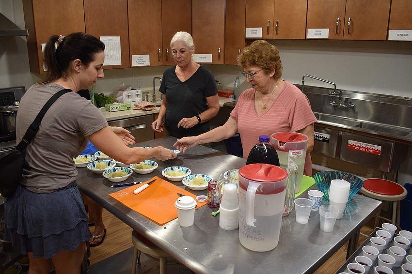 Volunteers Rebecca Murphy, Wendy Wicks, and Kathy Rance prepare the matzah balls.