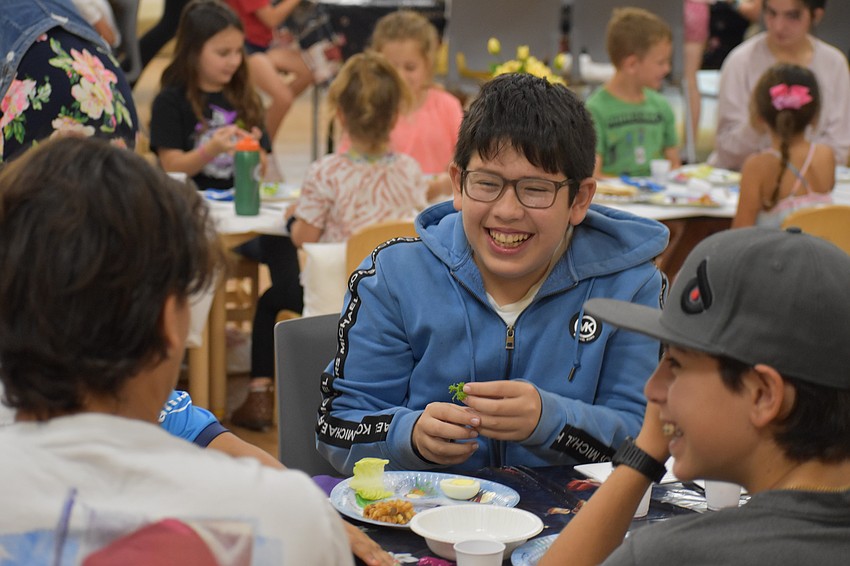 12-year-old Ian Gluzman prepares to eat the  lettuce.