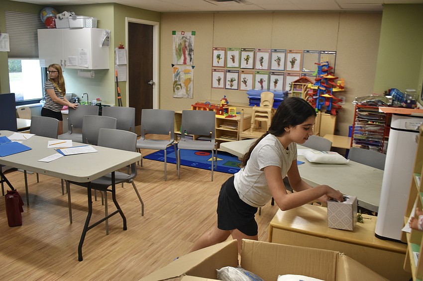 11-year-old Ada Johnson and 12-year-old Ariana Ackerman search for the afikoman.