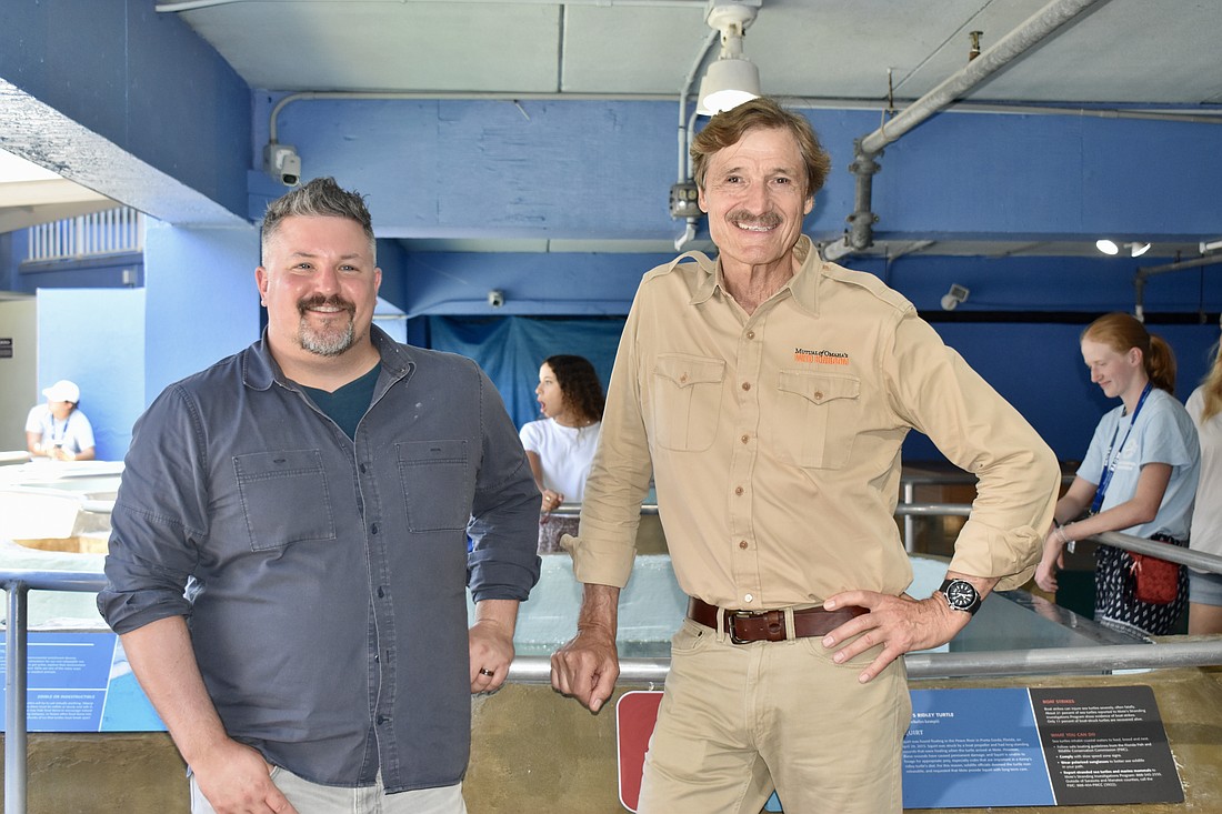 David Mizejewski and Peter Gros film an episode of Mutual of Omaha's Wild Kingdom at Mote Marine Laboratory & Aquarium in July.