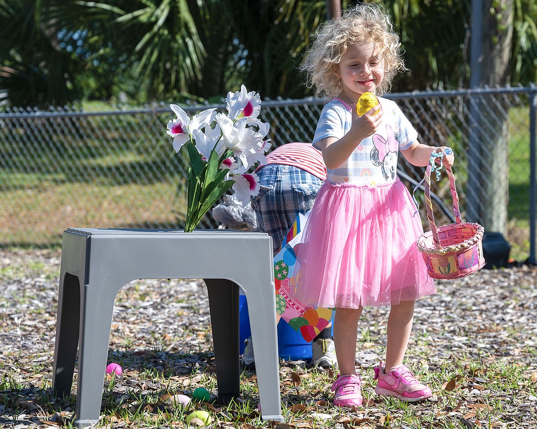 Stella Buccellato is delighted with the egg she found during the Easter egg hunt at the Tomoka United Methodist Church. Photo by Michele Meyers