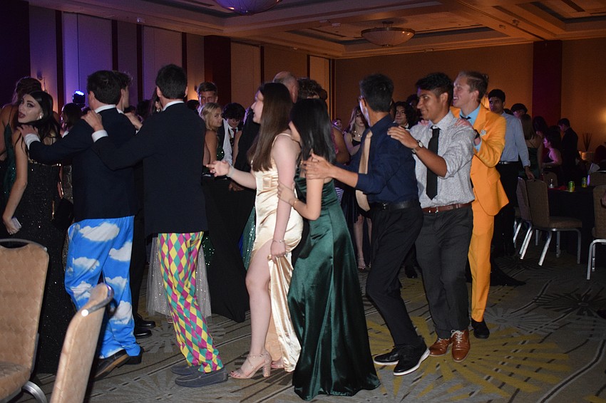 Students join a conga line going around the ballroom.