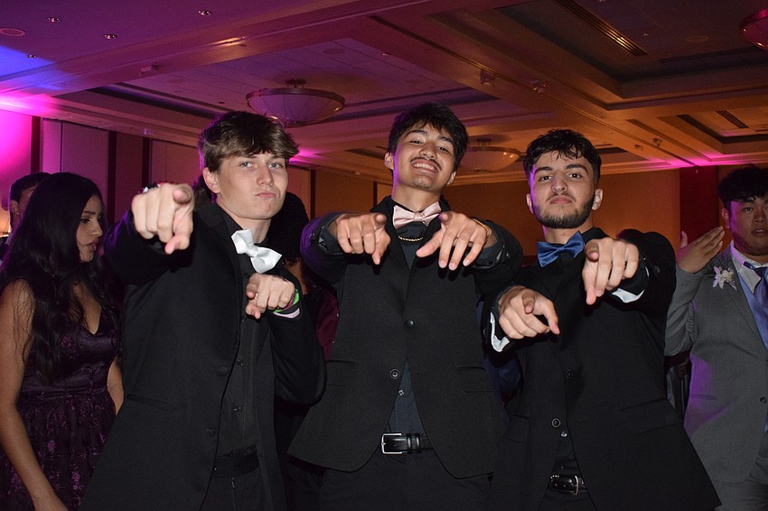 Seniors Cameron Boyer, Jeremiah Parker and Yazan Traish have fun together before dancing with classmates.