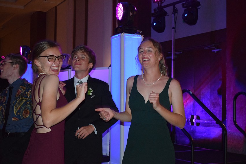 Senior Olivia Hunt, junior Ethan Zeitz and senior Leah Buchler are the first students to start dancing.