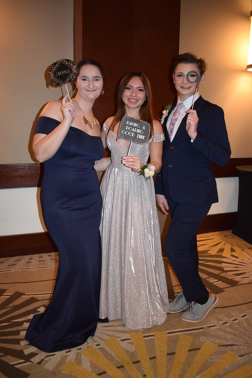Seniors Ashlee Hatcher, Lindsay Page and Josh Schwab have fun at their final prom.