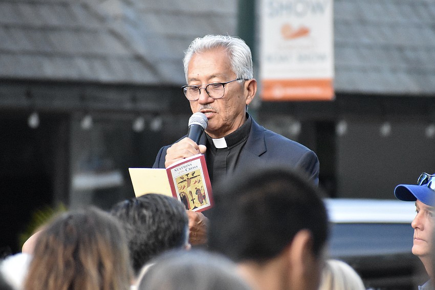 Deacon Humberto Alvia of St. Jude Catholic Church reads a passage in Spanish.