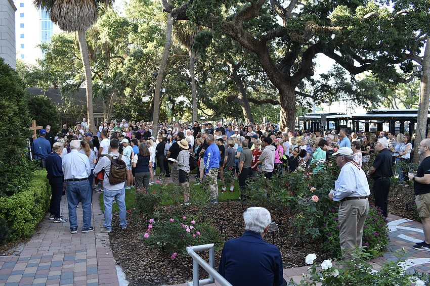 Walkers gather at the front of Church of the Redeemer as the walk ends.