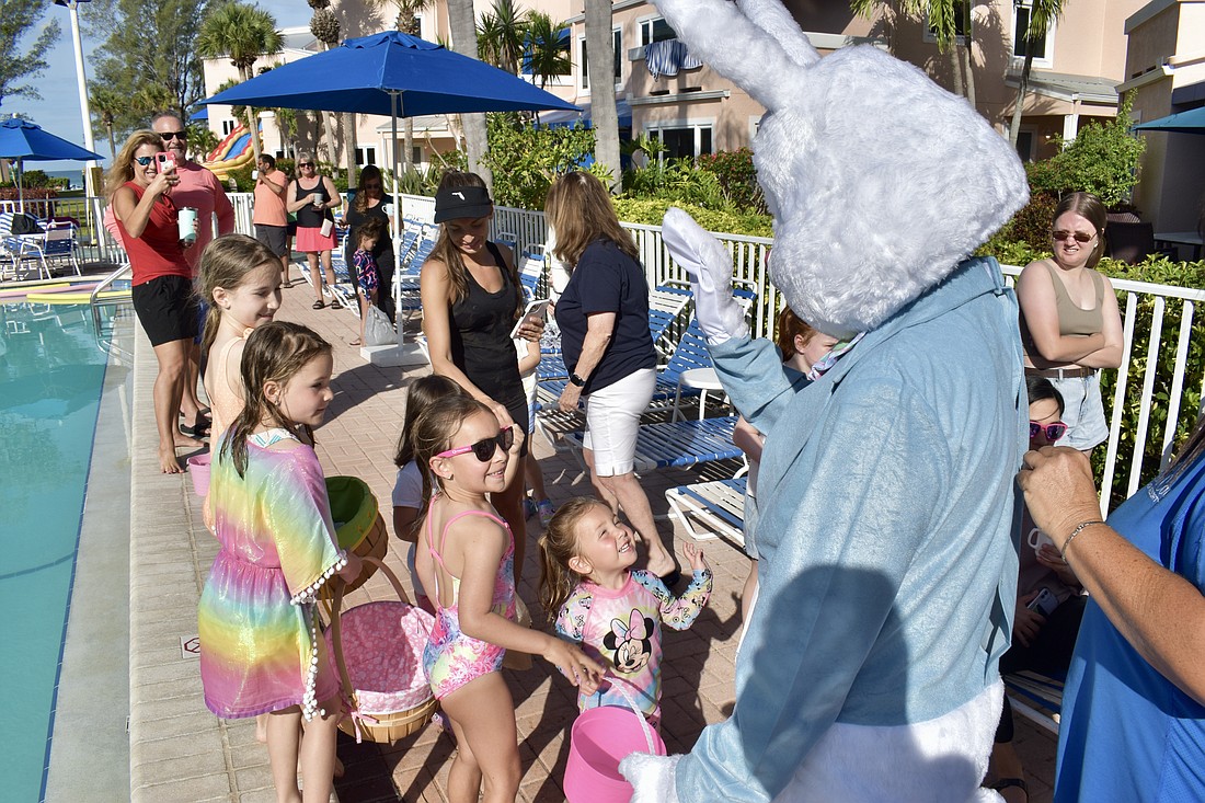 The Easter Bunny makes a stop at the Sand Cay Beach Resort on Friday.