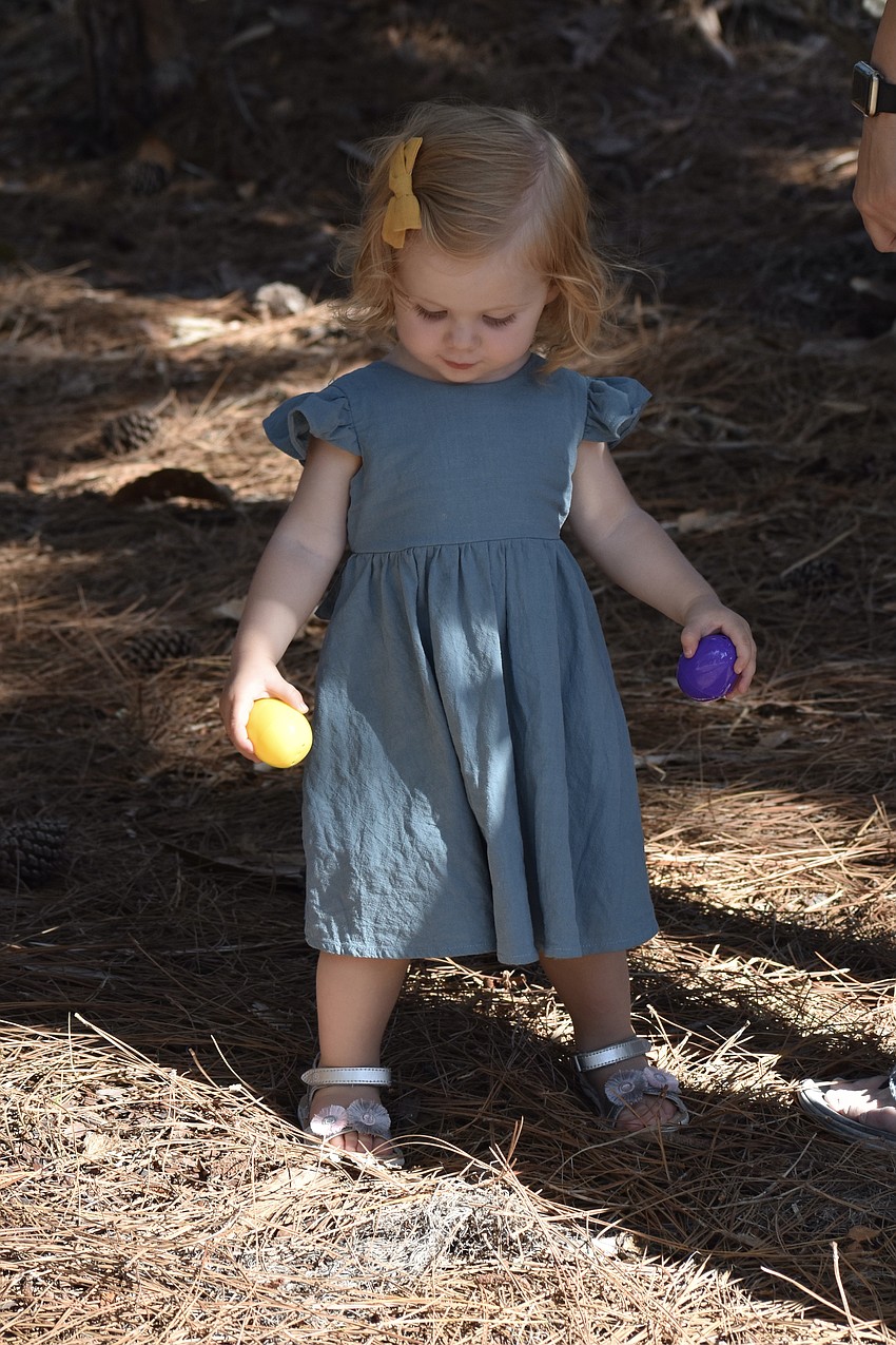 1-year-old Sage Leyendecker searches for even more eggs.