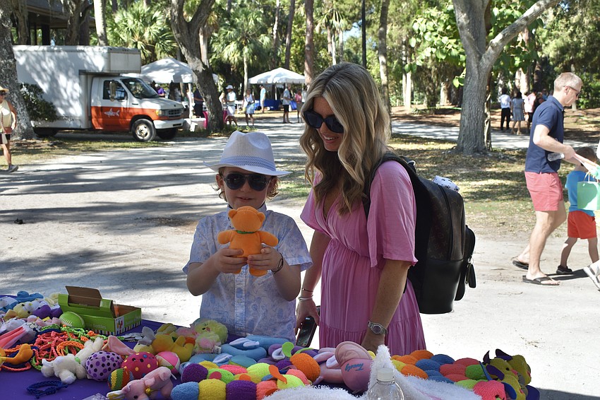8-year-old Joey Barak selects the perfect prize for bean bag toss with his mother Tiffany Barak.