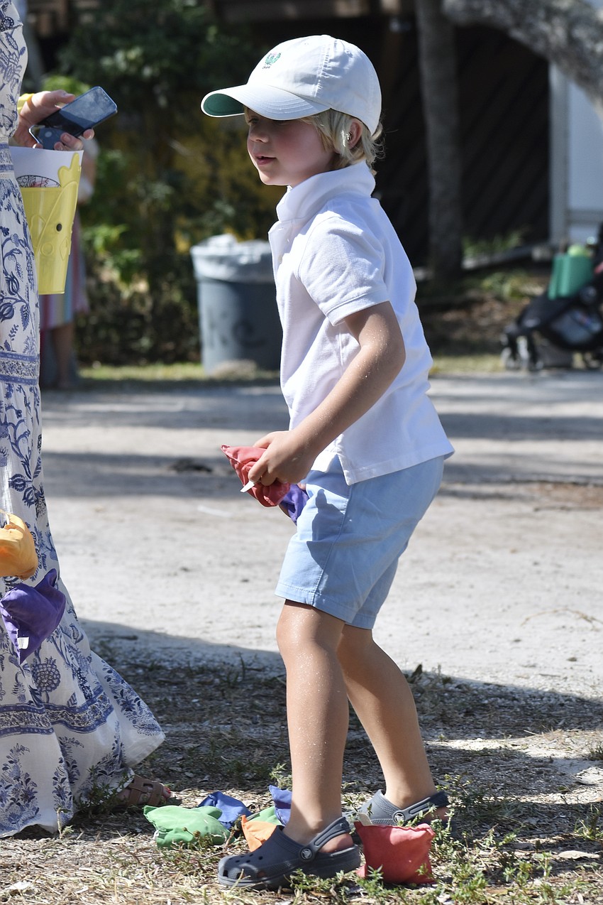 6-year-old George Barnet prepares to make a throw in a game of bean bag toss.