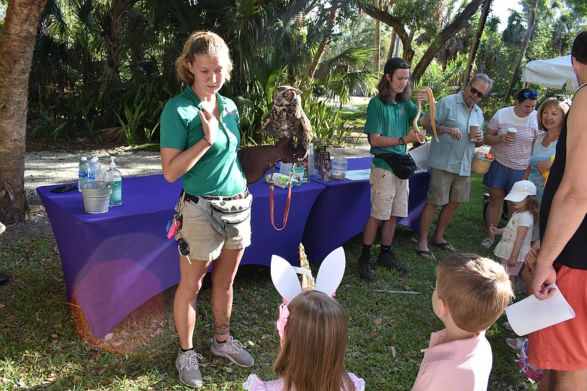 Becca Powell of Sarasota Jungle Gardens explains about owls to 3-year-old Eliana Egan and 4-year-old Macallister Egan