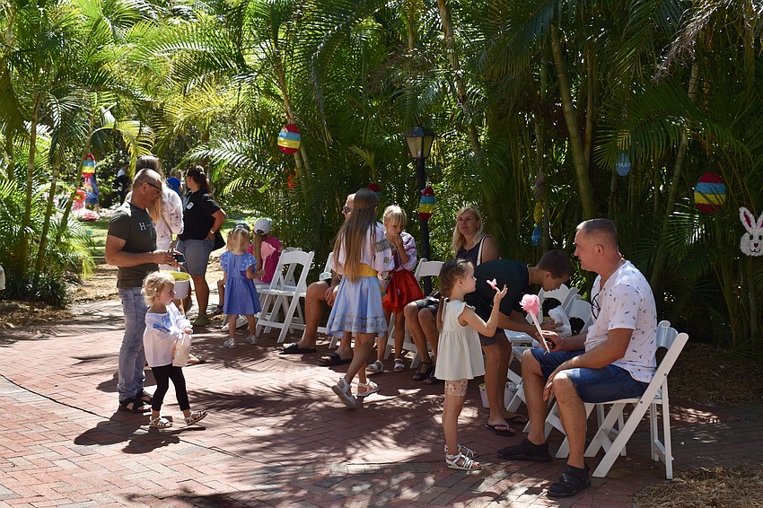Families gather in the courtyard to eat popcorn and cotton candy.