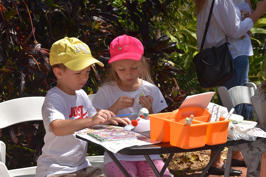 Yeva and Kiril paint Easter eggs.