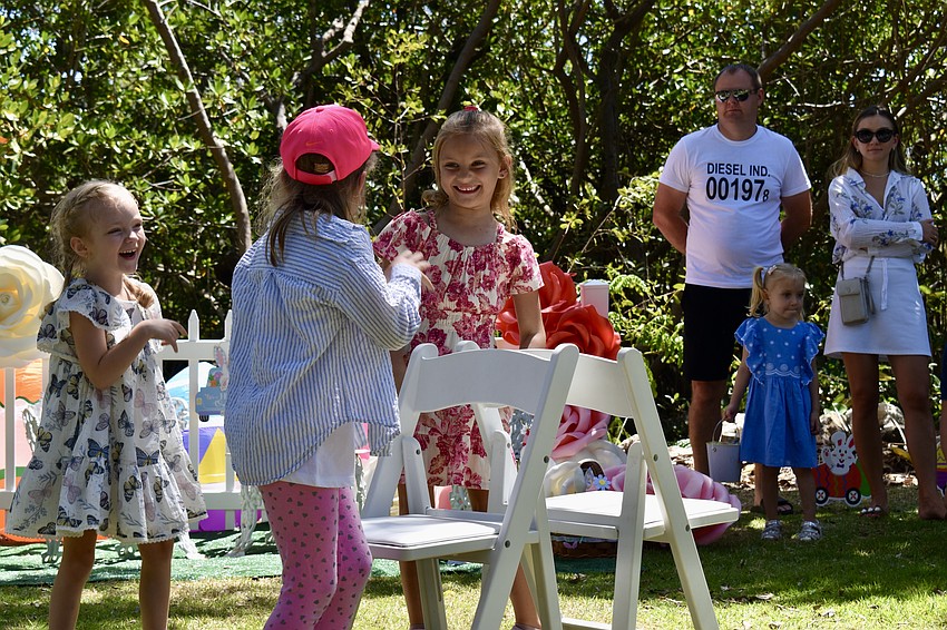 Elissa Anokhova and Scarlett Guidry laugh between rounds of musical chairs.