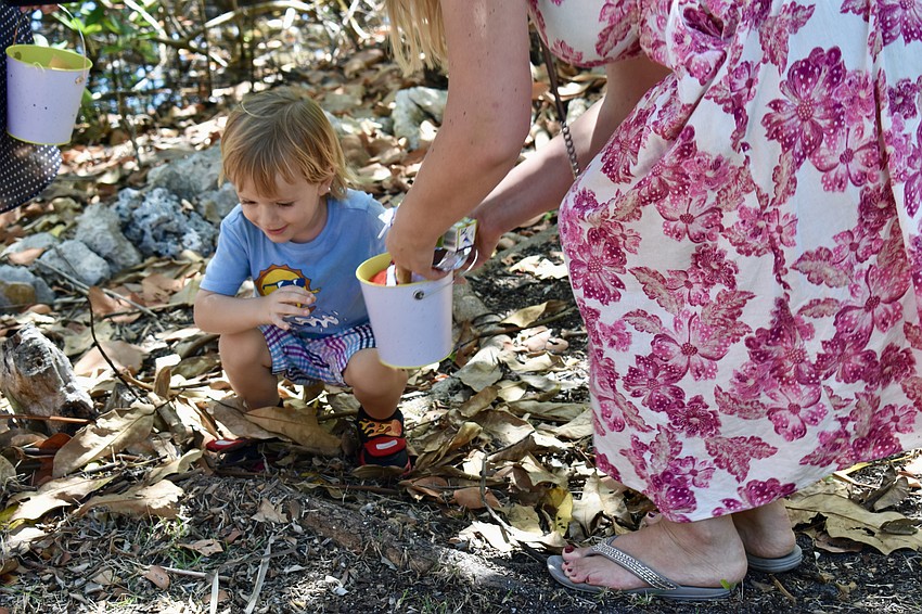 Robbie Guidry looks for Easter eggs with his mom.