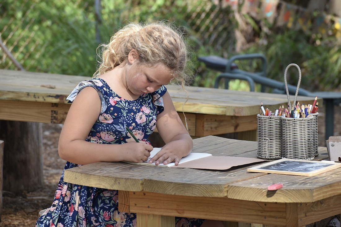7-year-old Lillian Huff works on a school assignment.