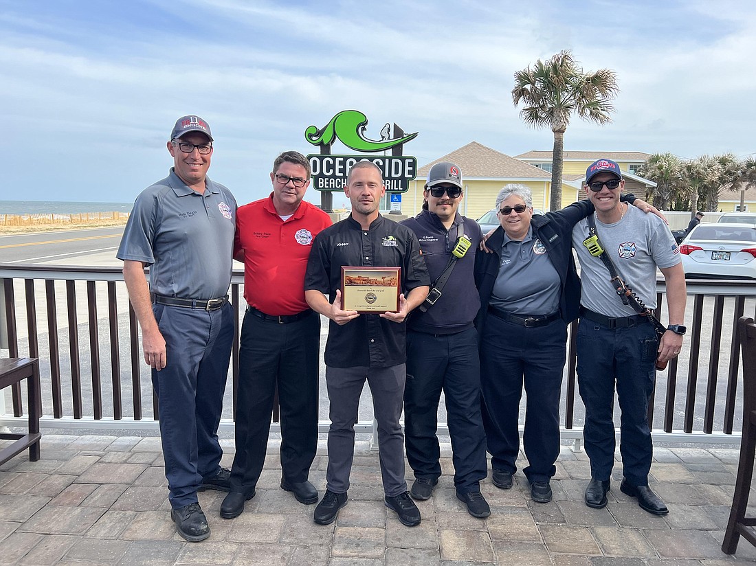 Oceanside's John Lulgjuraj was presented a plaque from Flagler Beach Firefighter Volunteer Association members Bob Deahl, Fire Chief Bobby Pace, Trey Poeira, Carrie Cardascia. Photo courtesy of Oceanside Beach Bar and Grill.