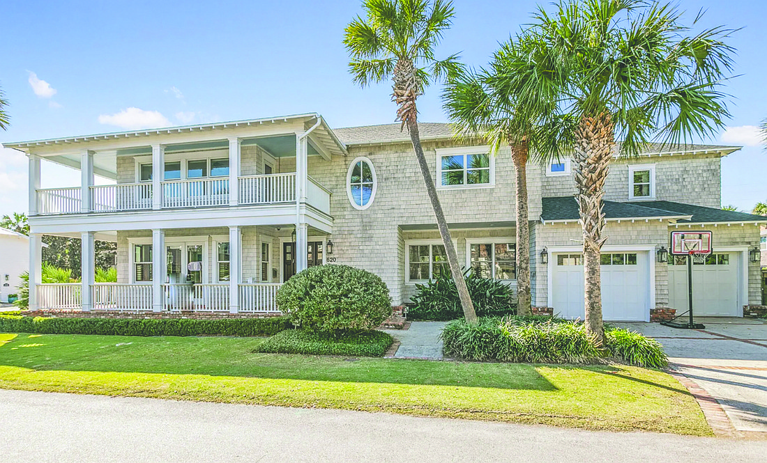 Two-story home features four bedrooms, four full and two half-bathrooms, wraparound porches, office, media room, pool, attached and detached garages with seven spaces and two driveways. Owner’s suite features ocean views.