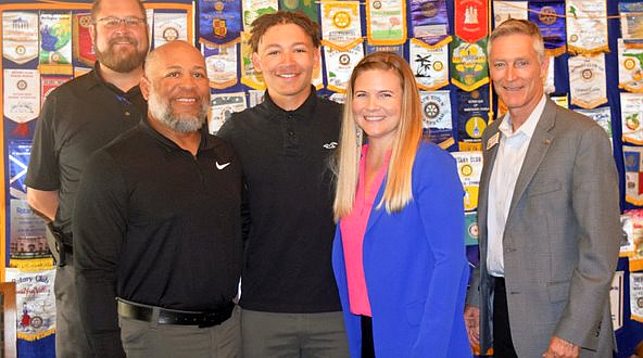 Rotary Club Coordinator Matt Maxwell (far left) and club President Jay Gardner (far right) with Gabe Breckenridge (center) and his parents, Lamont and Candi Breckenridge. Courtesy photo by Ken Neu