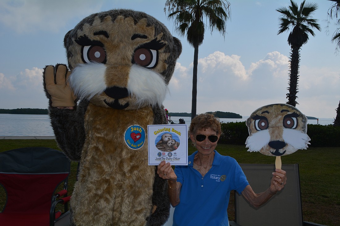 "Josh" the Otter and administrative secretary Janet Shapiro promoted water safety at the 2023 community open house.