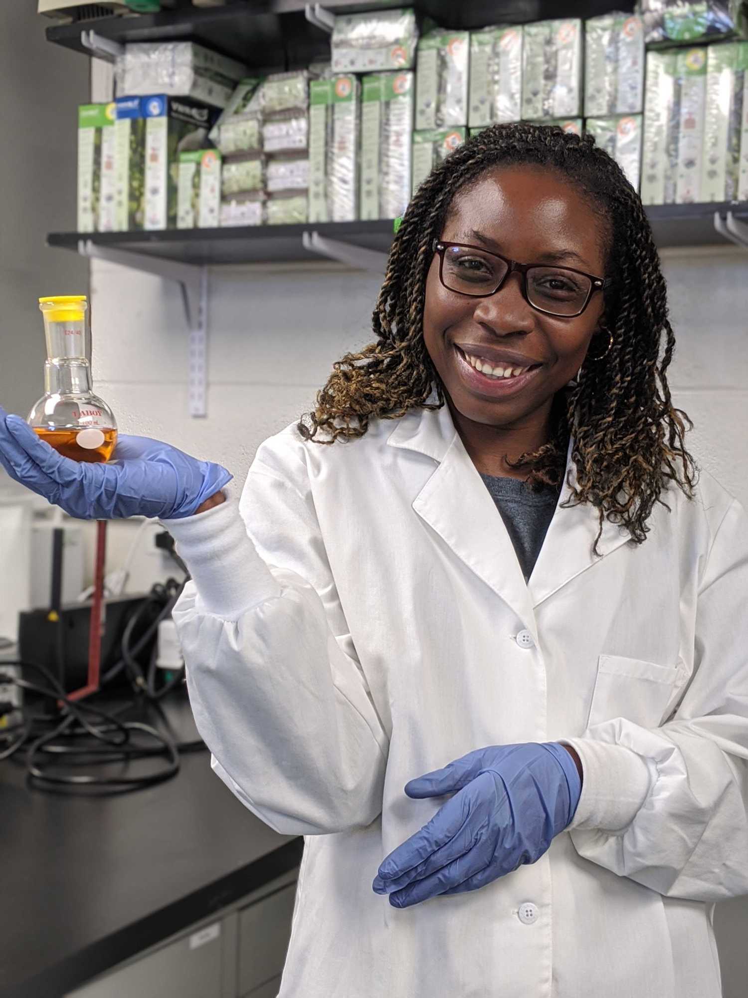 Dr. Kaweesa in the lab holding a flask of bacterial extract containing mensacarcin. Courtesy photo