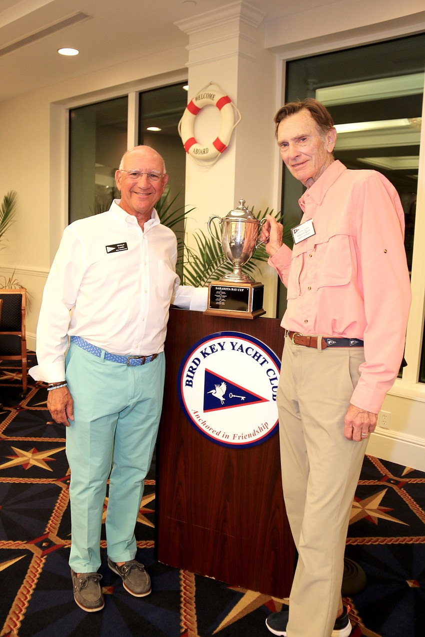 Michael Landis and Marvin Quin, co-chairs, hold the Sarasota Bay Cup at the award ceremony.