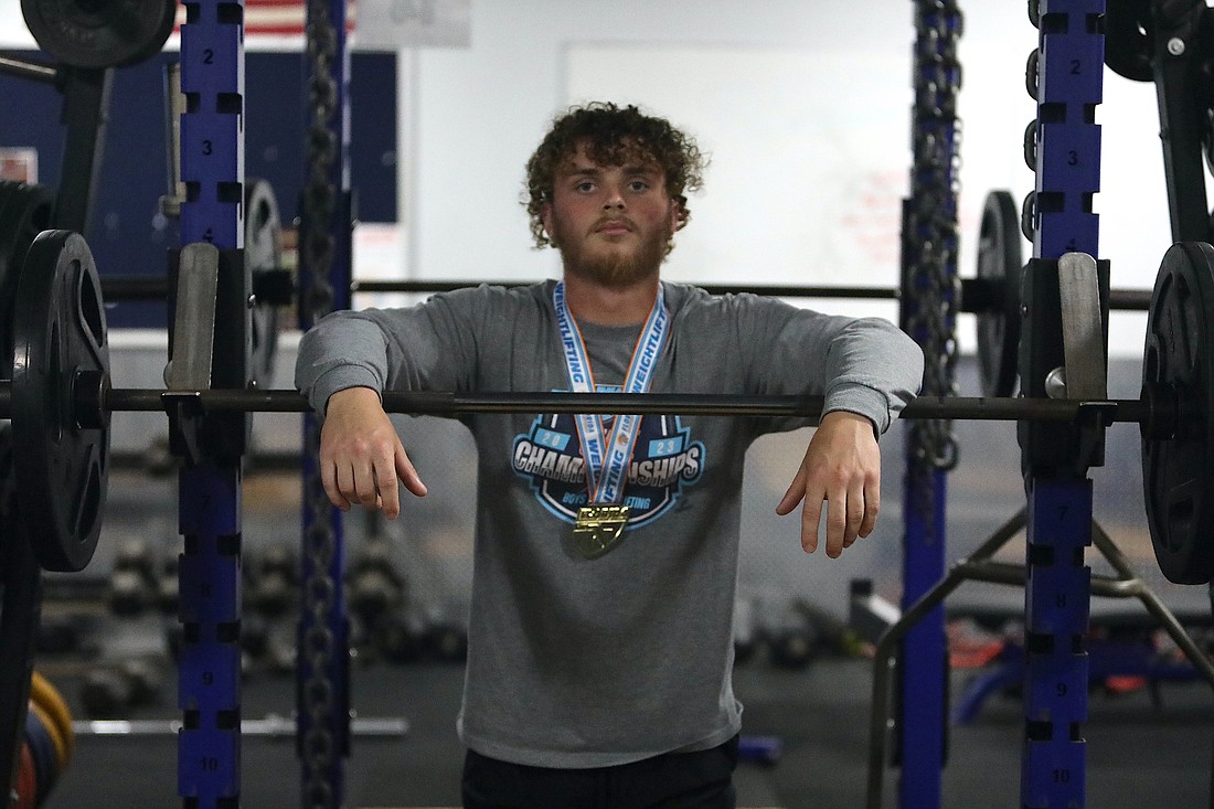 Cole Hash sports his gold medal in the Matanzas High School weight room, two days after winning a Class 2A state weightlifting championship. Photo by Brent Woronoff