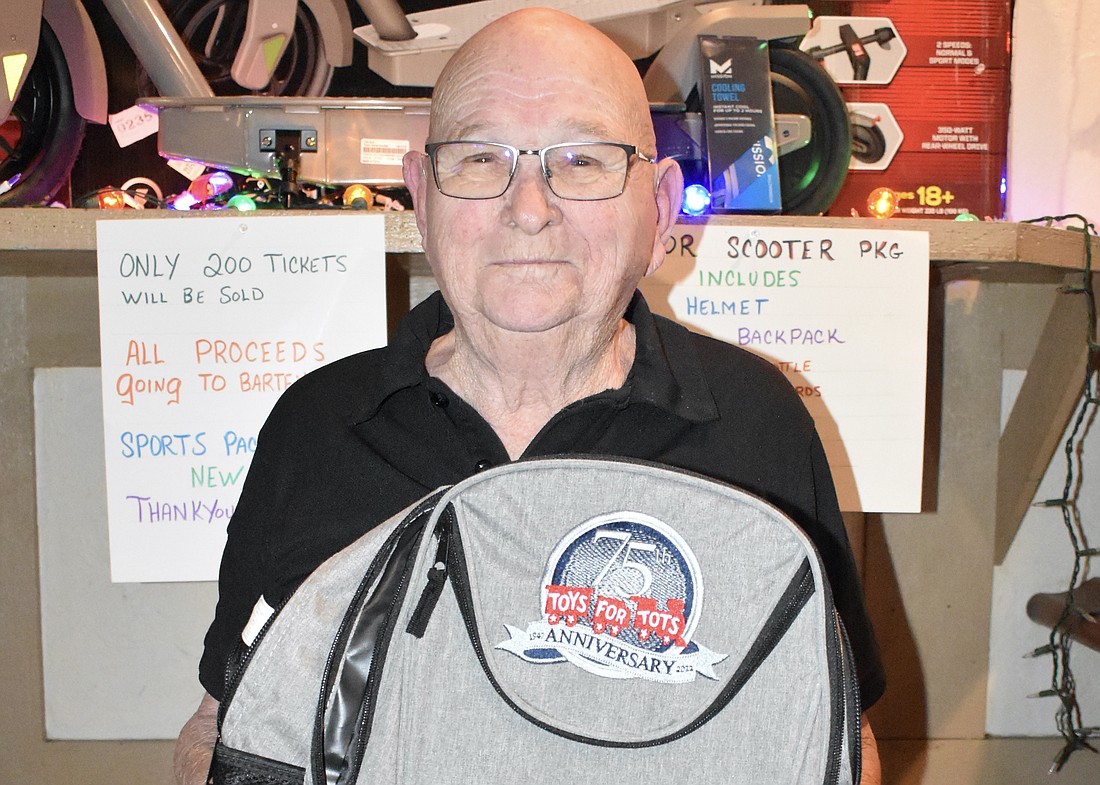 Jim Lamb holds a Toys for Tots backpack.