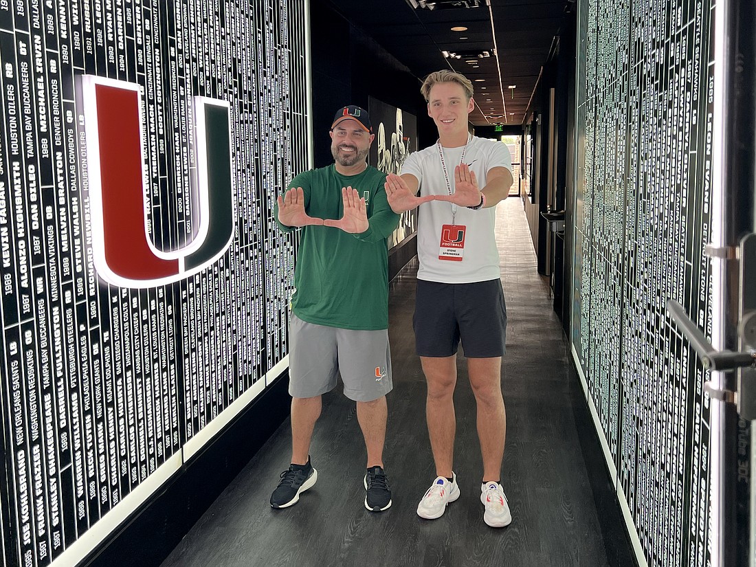 Miami special teams Coach Marwan Maalouf and Stone Springman throw up "The U" hand gesture on Springman's visit to the school.