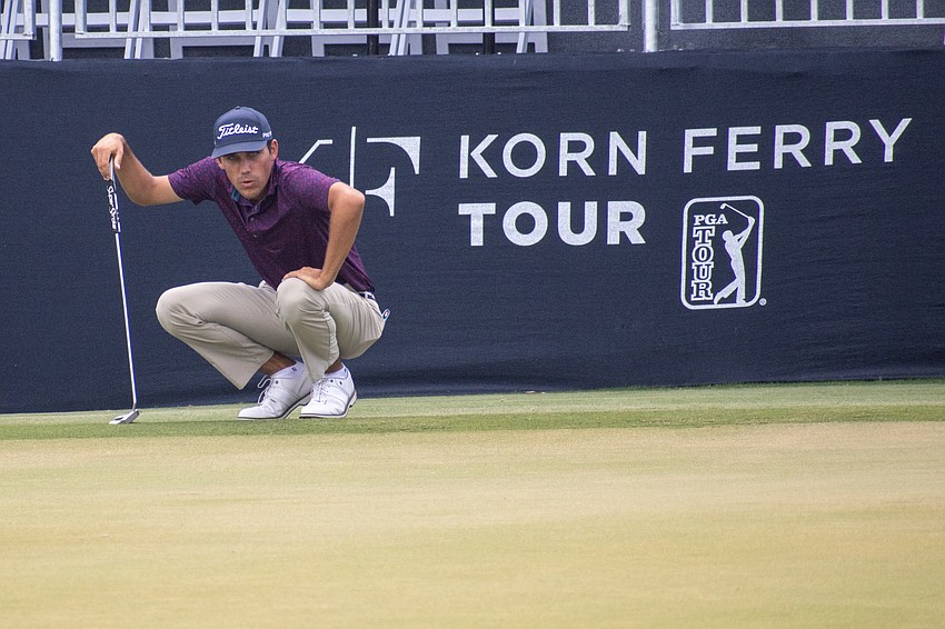 Carter Page examines the green on the No. 18 hole at Lakewood National. Page shot two under par during round two of the 2023 LECOM Suncoast Classic and is one under par for the tournament.