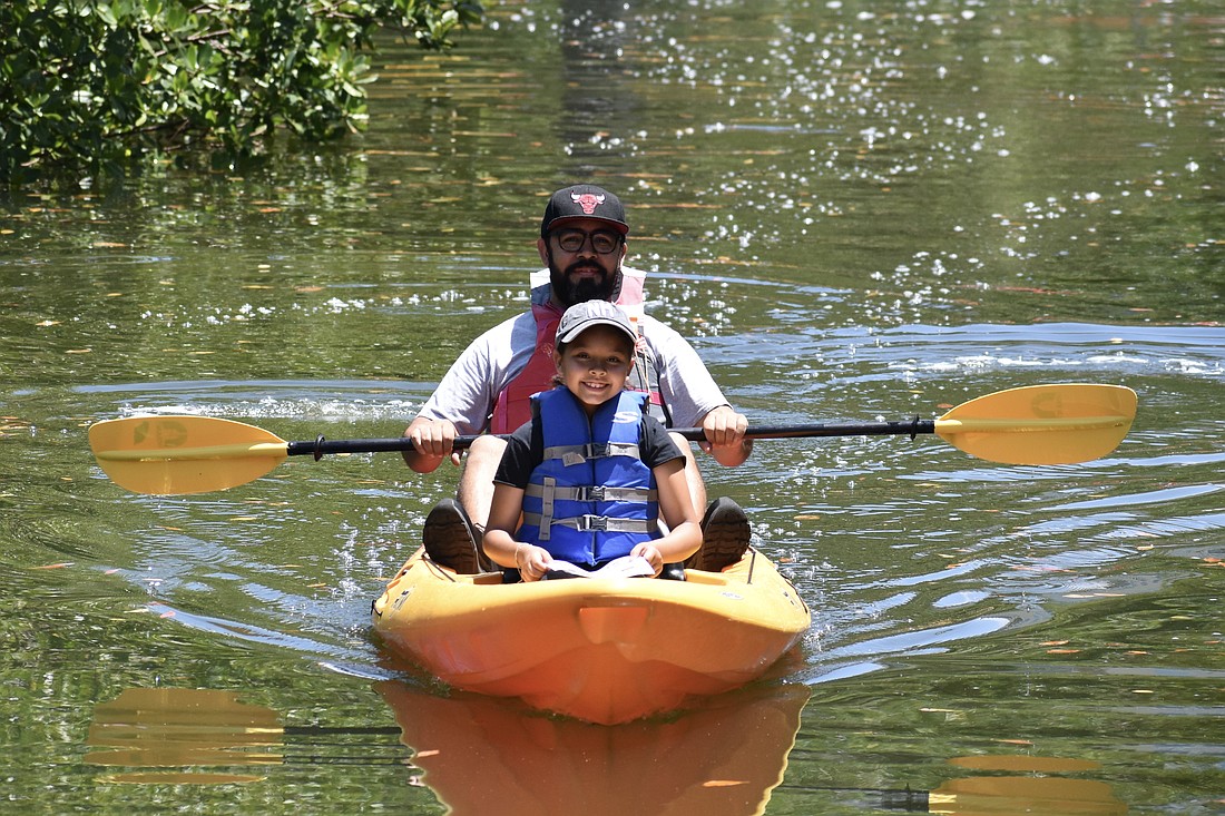 Eddie Alarcon and 8-year-old Leyla Alarcon head out on a free kayaking trip April 22, 2023, at Earth Day at The Bay.
