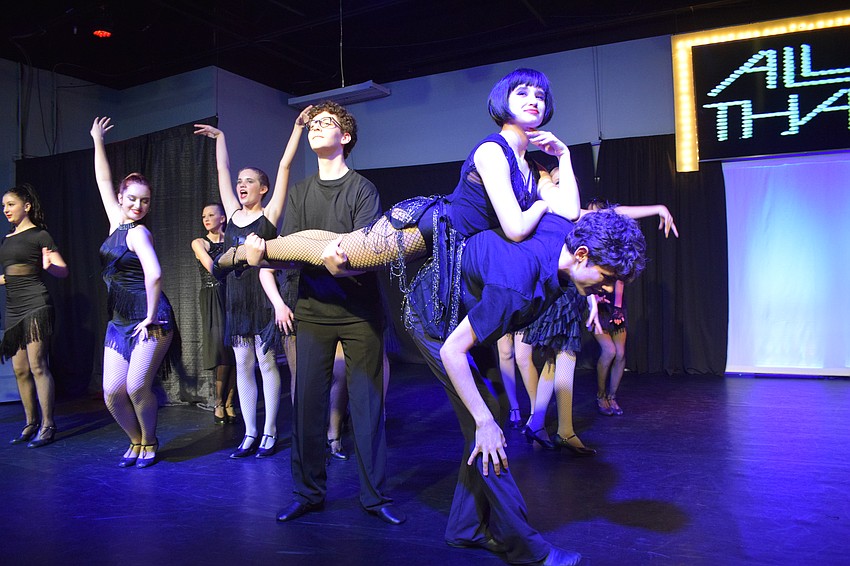 Isaiah Yates and Eduardo Zoppe hold up Emma Mandzik, who is portraying Velma Kelly, in the opening number of the teen edition of 