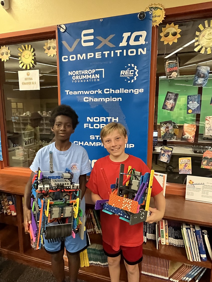 Gilbert W. McNeal Elementary School fifth graders Symian Porter and Sawyer Ritz are excited their team, the Multicolor Madness, will compete at the VEX Robotics World Championships.