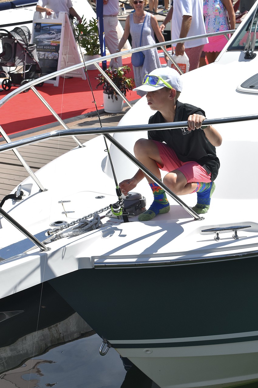 10-year-old Morgan Welling fishes using a pole he gained from the fishing clinic.