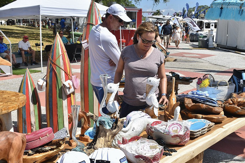 Erik and Karen Bergenholtz browse woodcarvings at the boat show.
