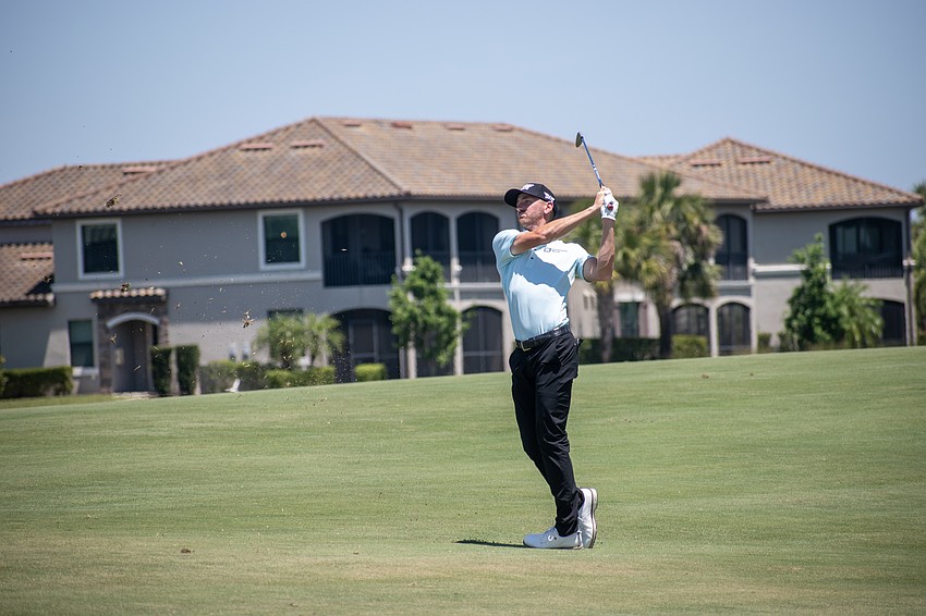 Kevin Dougherty hits his second shot on the No. 1 hole at Lakewood National. Dougherty would birdie the hole.
