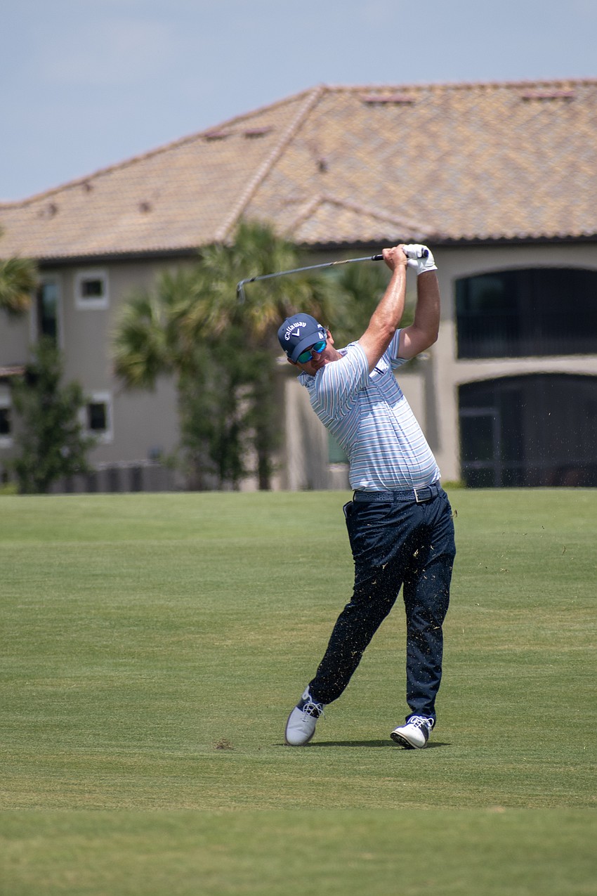 Ryan Blaum hits his second shot on the No. 18 hole at Lakewood National. Blaum shot four under par Sunday and finished the tournament 14 under par.