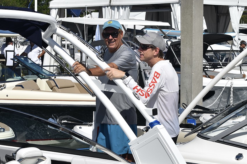 Walter Turek and Paul Bloom discuss the boats on display.