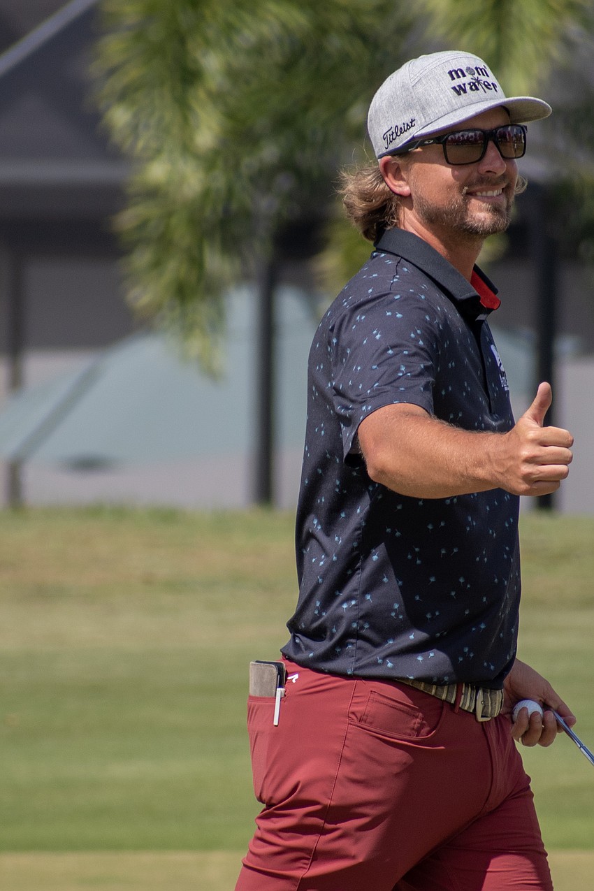 Rhein Gibson flashes a thumbs-up after a birdie putt on the No. 17 hole.