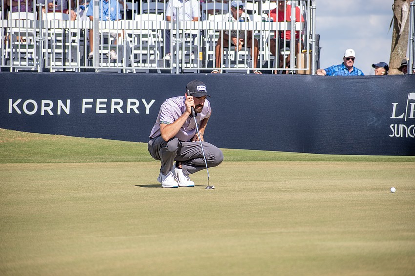 Chase Seiffert examines the green on the No. 18 hole at Lakewood National. Seiffert finished the tournament tied for third at 20 under par.